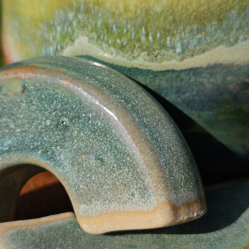 Detail of a green-blue glazed ceramic form